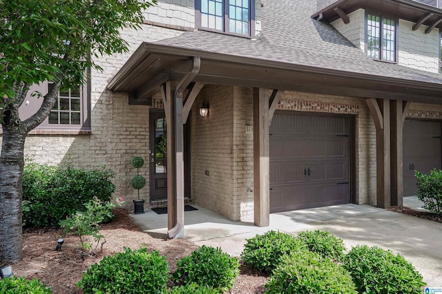 1186 Inverness Cove Way, Hoover, AL 35242 - view of exterior entry featuring roof with shingles, a garage, and concrete driveway