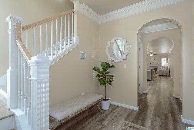 1186 Inverness Cove Way, Hoover, AL 35242 - corridor with wood finished floors, ornamental molding, stairs, and arched walkways