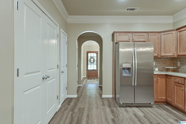 1186 Inverness Cove Way, Hoover, AL 35242 - kitchen with stainless steel refrigerator with ice dispenser, arched walkways, light wood-type flooring, ornamental molding, and backsplash