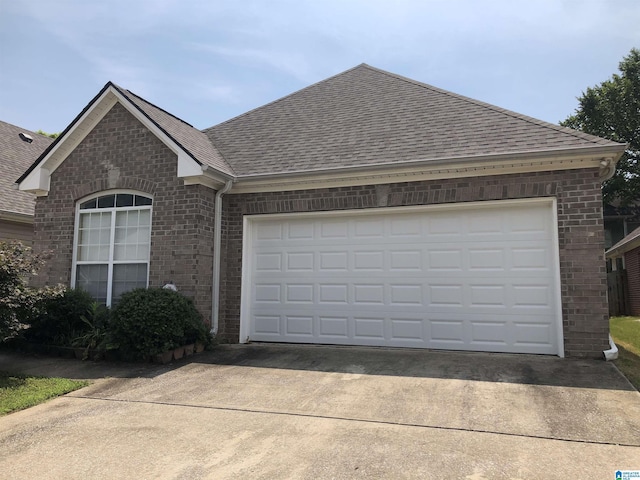 155 Highview Cv, Pelham, AL 35124 - view of front of house featuring brick siding, a shingled roof, concrete driveway, and a garage