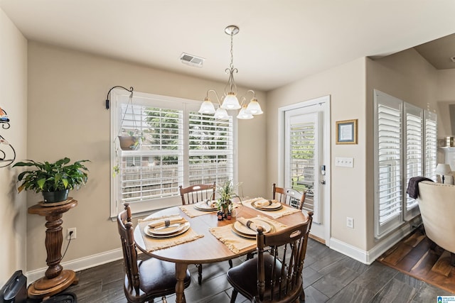 417 Rock View Trl, Maylene, AL 35114 - dining area with a chandelier and dark wood-type flooring