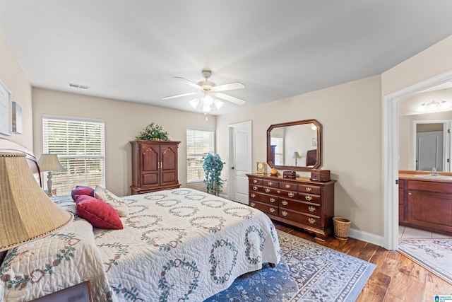 417 Rock View Trl, Maylene, AL 35114 - bedroom with wood finished floors, ceiling fan, and ensuite bathroom