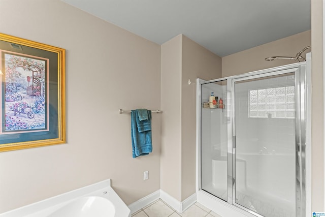 417 Rock View Trl, Maylene, AL 35114 - bathroom featuring a shower stall, tile patterned flooring, and a garden tub
