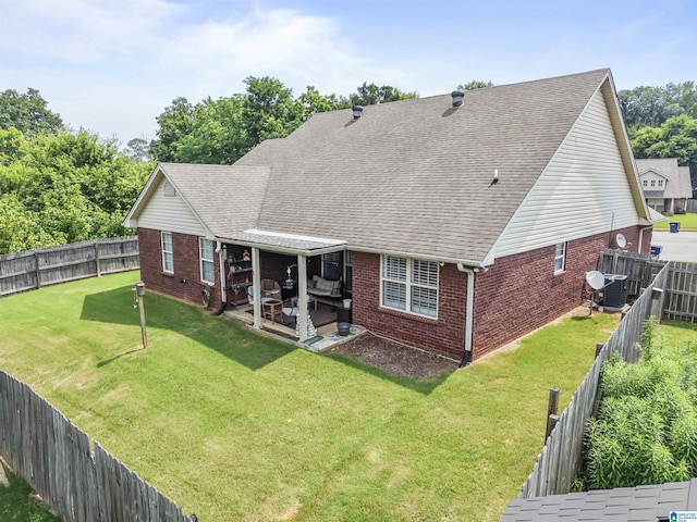 417 Rock View Trl, Maylene, AL 35114 - rear view of house with brick siding, a patio area, a fenced backyard, and a shingled roof