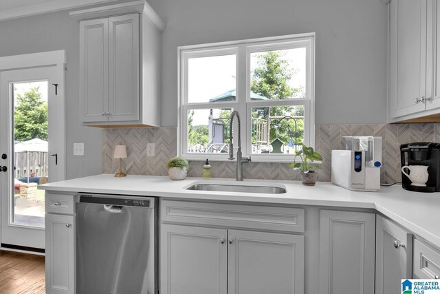 7808 Jayden Dr, Trussville, AL 35173 - kitchen with dishwasher, light countertops, tasteful backsplash, and wood finished floors