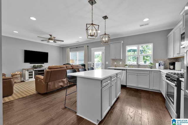 7808 Jayden Dr, Trussville, AL 35173 - kitchen with appliances with stainless steel finishes, dark wood finished floors, ornamental molding, light countertops, and open floor plan