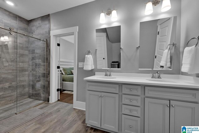 7808 Jayden Dr, Trussville, AL 35173 - ensuite bathroom with double vanity, a shower stall, and wood finished floors