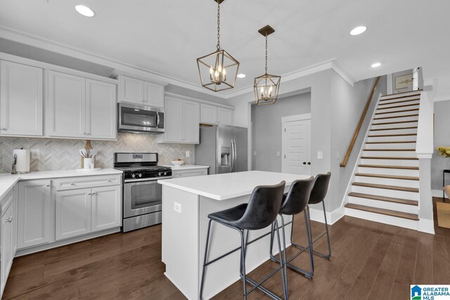 7808 Jayden Dr, Trussville, AL 35173 - kitchen with appliances with stainless steel finishes, ornamental molding, a center island, a breakfast bar, and recessed lighting