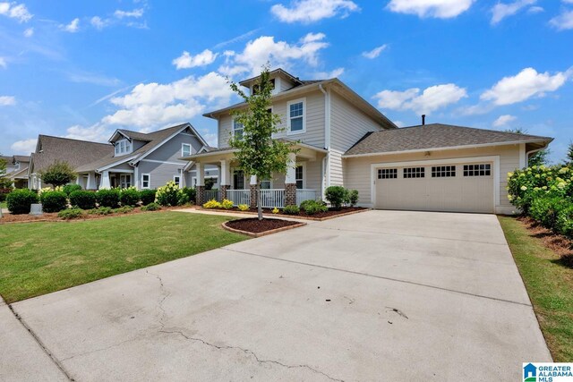 7808 Jayden Dr, Trussville, AL 35173 - view of front facade with concrete driveway, an attached garage, a porch, and a front yard