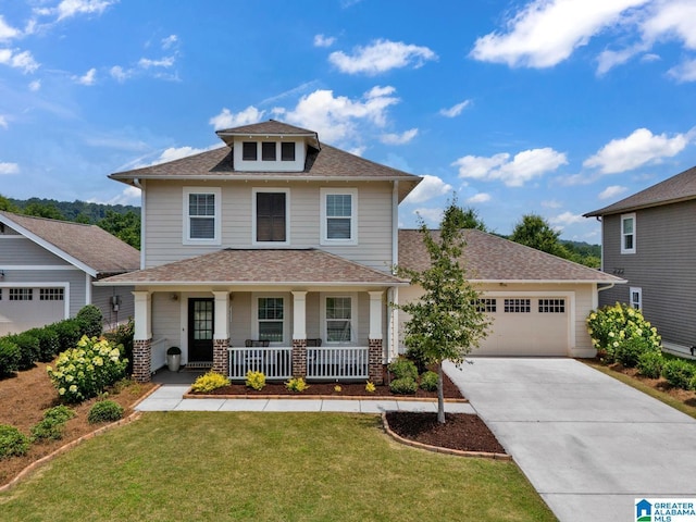 7808 Jayden Dr, Trussville, AL 35173 - american foursquare style home with covered porch, an attached garage, concrete driveway, roof with shingles, and a front lawn