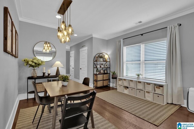 7808 Jayden Dr, Trussville, AL 35173 - dining area featuring a chandelier, wood finished floors, and ornamental molding
