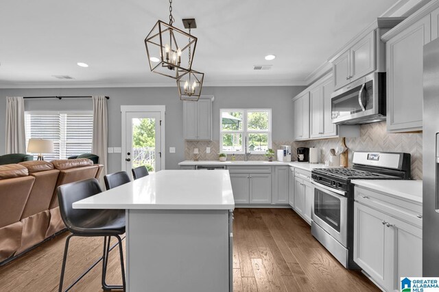 7808 Jayden Dr, Trussville, AL 35173 - kitchen featuring appliances with stainless steel finishes, a kitchen breakfast bar, open floor plan, a chandelier, and light countertops