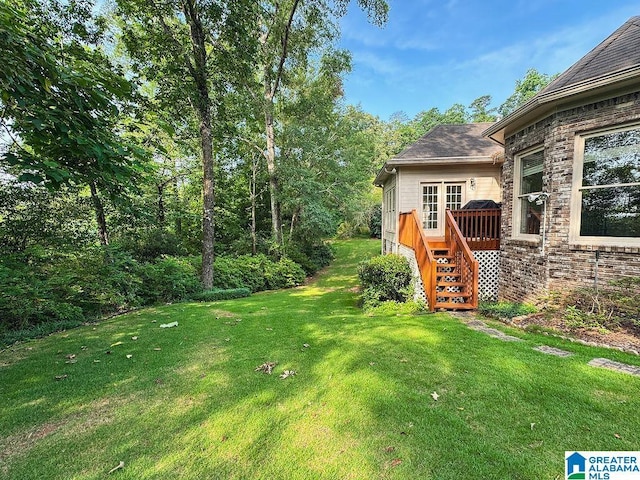 4205 Waterford Ln, Trussville, AL 35173 - view of grassy yard with stairway and a deck