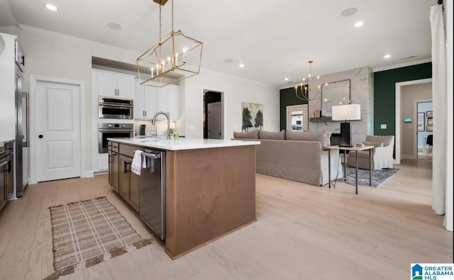 500 Simms Lndg, Pelham, AL 35124 - kitchen with a chandelier, appliances with stainless steel finishes, crown molding, a center island with sink, and white cabinets