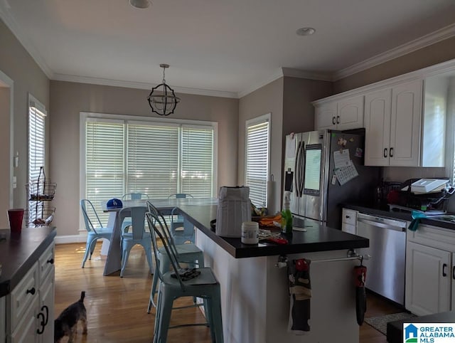 100 Emily Cir, Birmingham, AL 35242 - kitchen with stainless steel appliances, dark countertops, wood finished floors, white cabinets, and crown molding