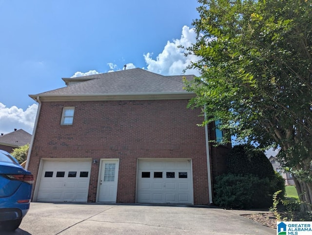 100 Emily Cir, Birmingham, AL 35242 - view of side of property with a garage, driveway, brick siding, and roof with shingles