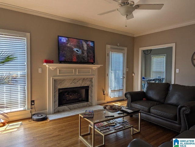 100 Emily Cir, Birmingham, AL 35242 - living room featuring wood finished floors, crown molding, a ceiling fan, and healthy amount of natural light