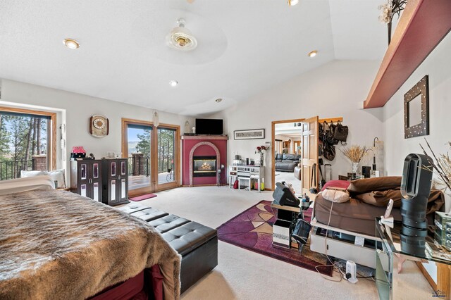 carpeted bedroom featuring access to exterior, high vaulted ceiling, and multiple windows