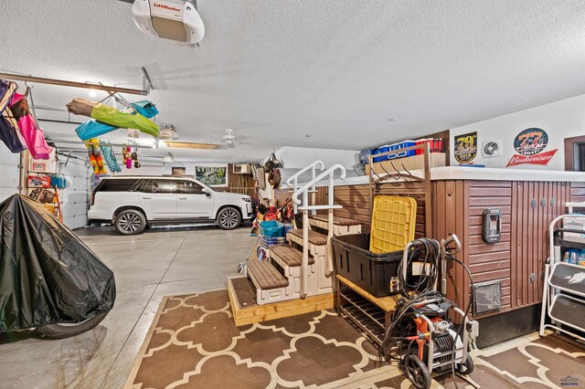 garage featuring a garage door opener and ceiling fan