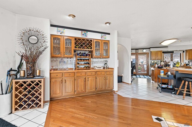 bar with light hardwood / wood-style flooring