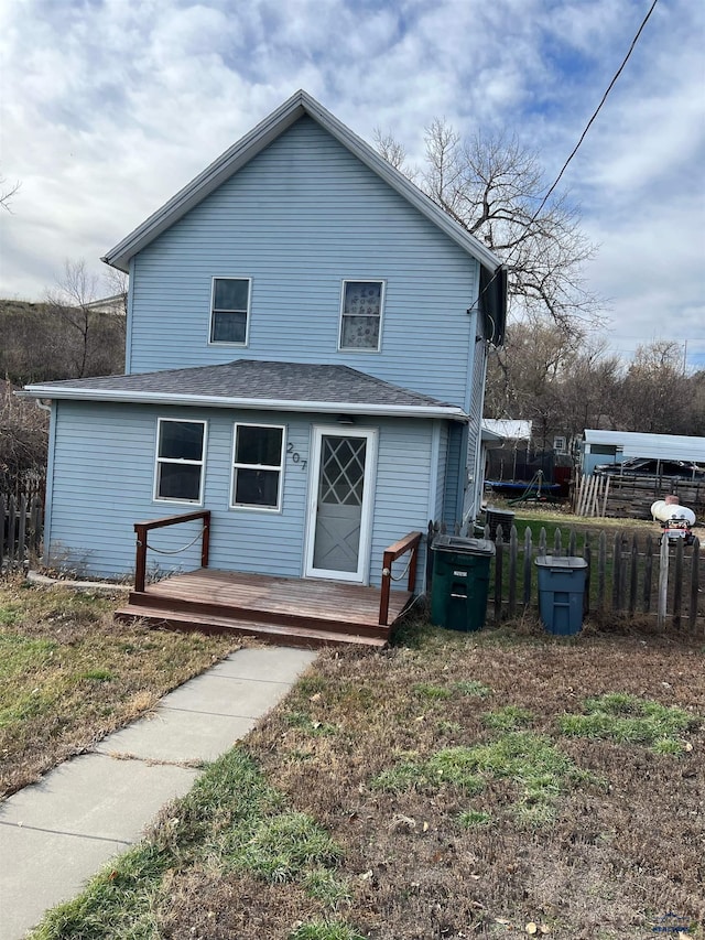 back of house with a wooden deck