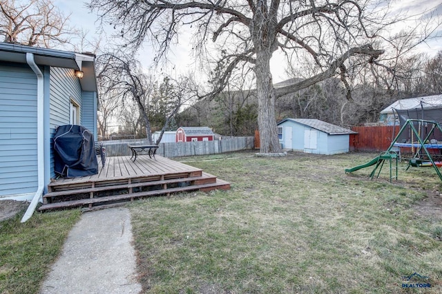 view of yard with a storage unit and a wooden deck