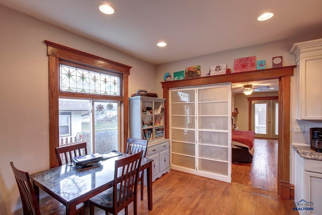 dining area with light hardwood / wood-style floors and ceiling fan