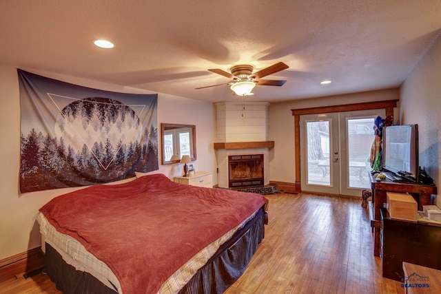 bedroom with ceiling fan, light hardwood / wood-style flooring, access to outside, and french doors