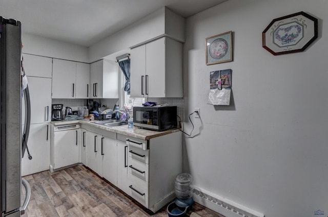 601 Haines Ct, Rapid City, SD 57701 - kitchen featuring backsplash, light hardwood / wood-style floors, stainless steel appliances, and white cabinets