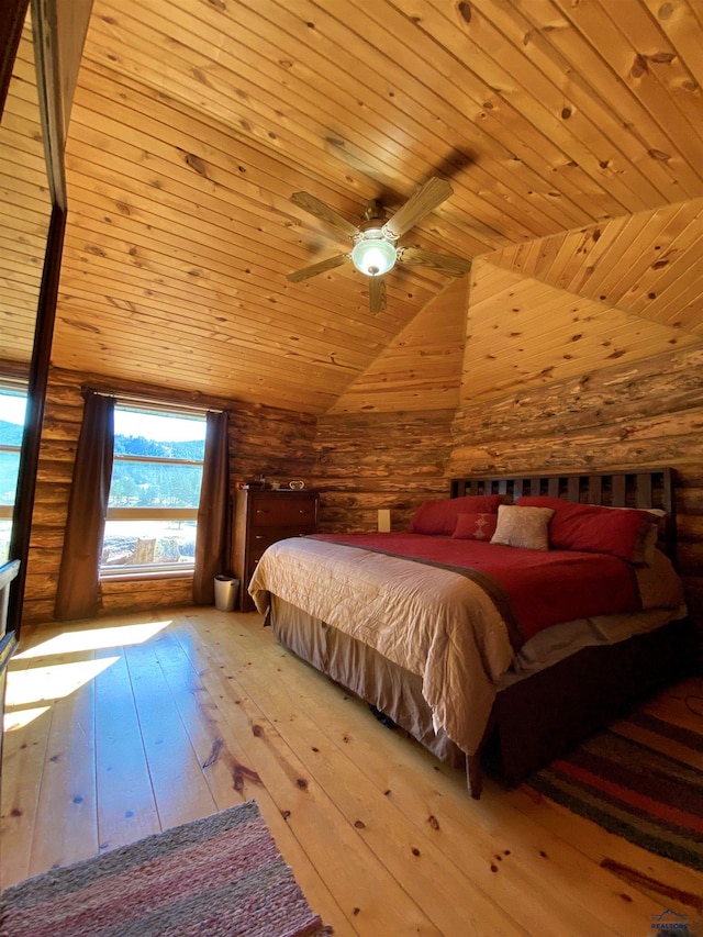 bedroom featuring log walls, vaulted ceiling, ceiling fan, wooden ceiling, and light hardwood / wood-style flooring