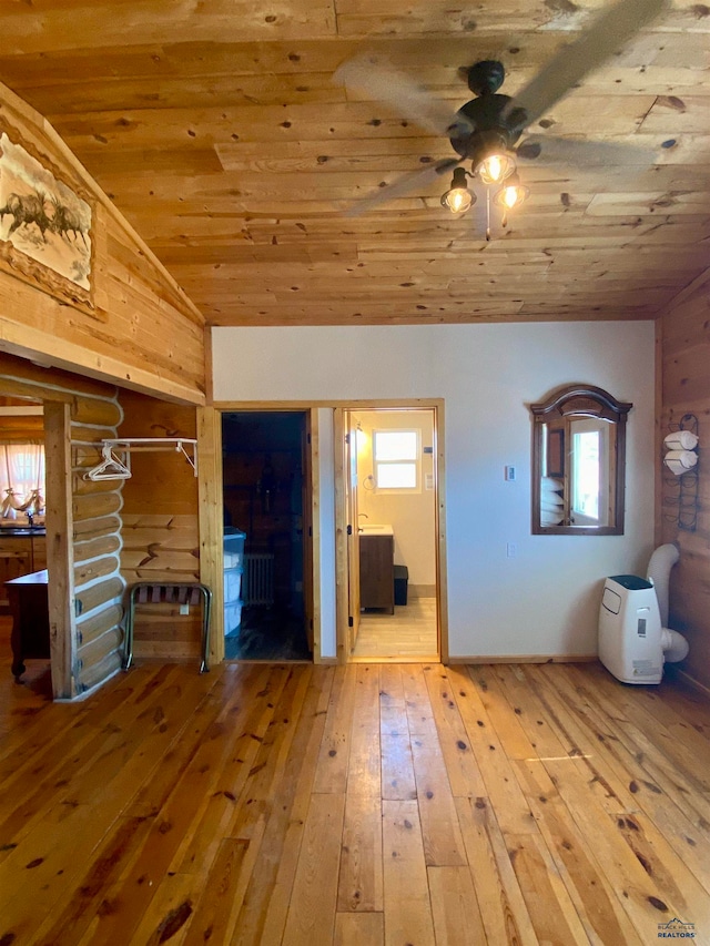 interior space with ceiling fan, light hardwood / wood-style flooring, wood ceiling, and vaulted ceiling