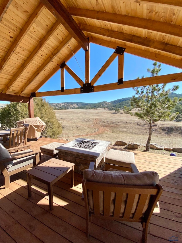 wooden deck featuring an outdoor fire pit