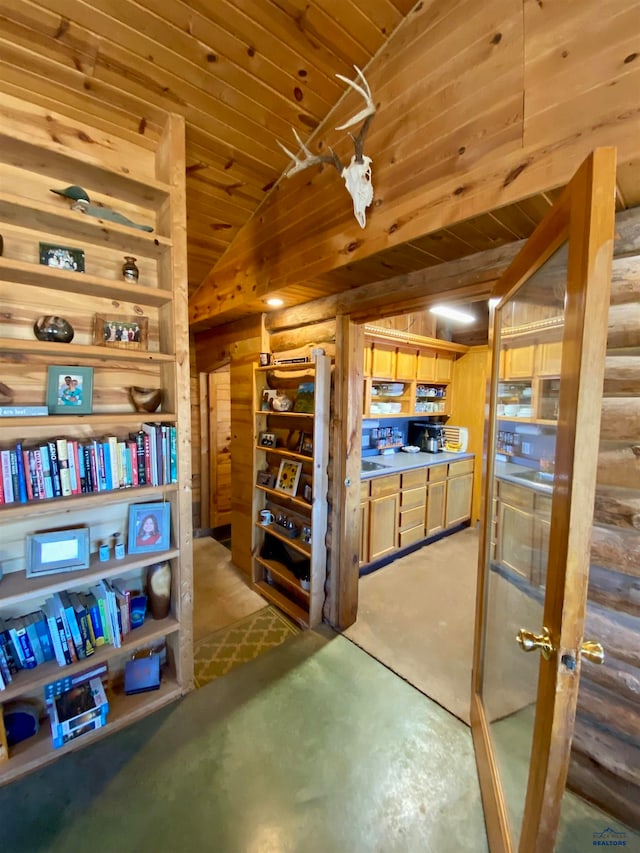 interior space featuring wood walls, lofted ceiling, and wooden ceiling