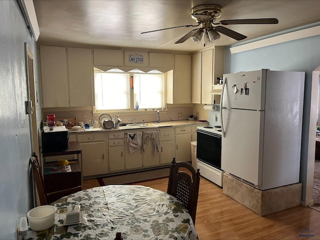 kitchen with sink, ceiling fan, extractor fan, white appliances, and light wood-type flooring