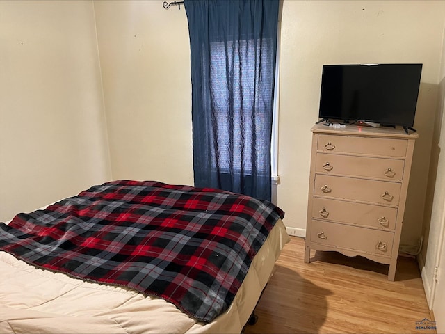 bedroom with light wood-type flooring