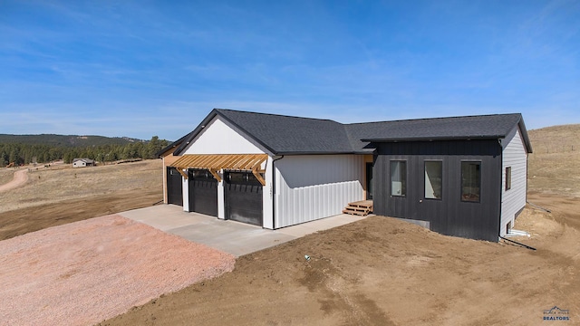 view of front facade featuring an outdoor structure and a garage