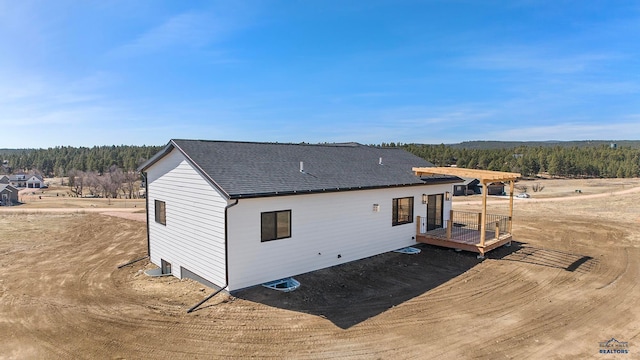 rear view of property featuring central AC and a wooden deck