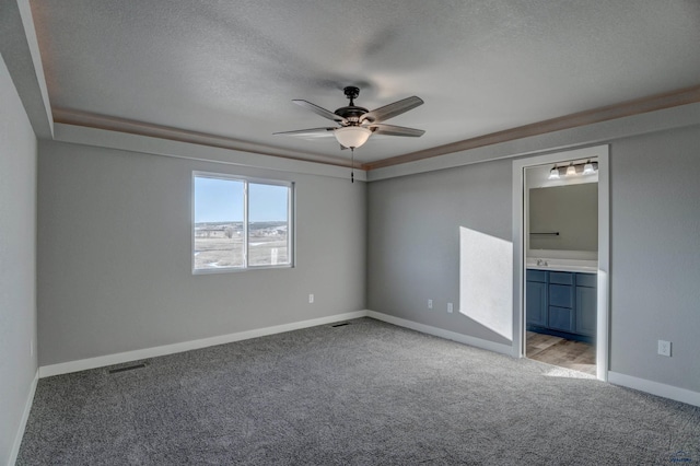 unfurnished room featuring light colored carpet, a textured ceiling, sink, and ceiling fan