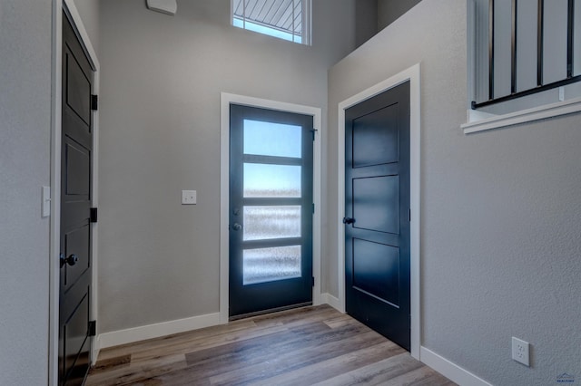 foyer entrance with light wood-type flooring