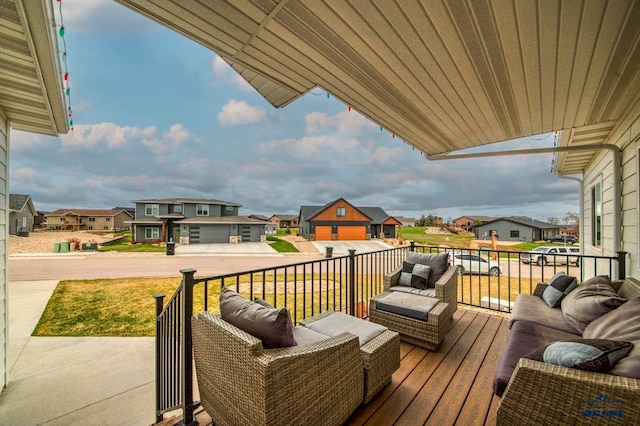 wooden terrace with a garage and outdoor lounge area