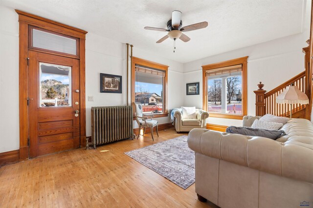 735 8th, Spearfish, SD 57783 - living room with light hardwood / wood-style flooring, ceiling fan, and radiator