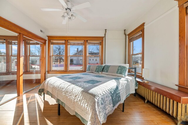 735 8th, Spearfish, SD 57783 - bedroom with hardwood / wood-style flooring, radiator, and ceiling fan