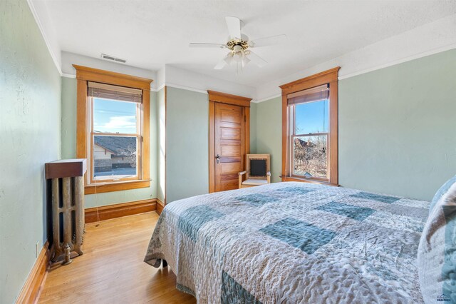 735 8th, Spearfish, SD 57783 - bedroom featuring crown molding, ceiling fan, and hardwood / wood-style floors