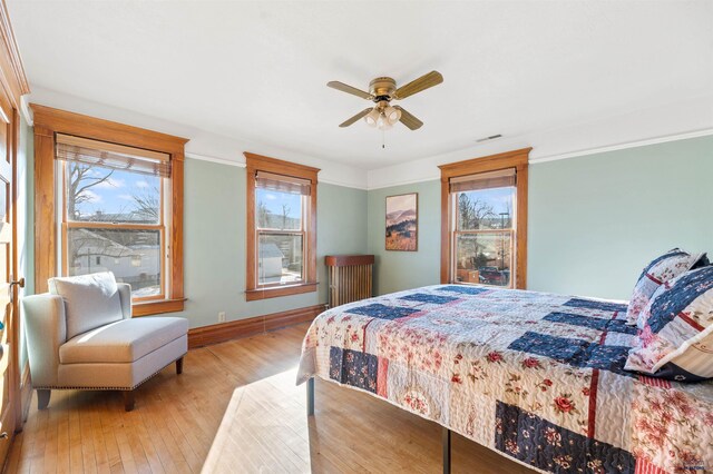 735 8th, Spearfish, SD 57783 - bedroom featuring hardwood / wood-style floors, ornamental molding, multiple windows, and ceiling fan