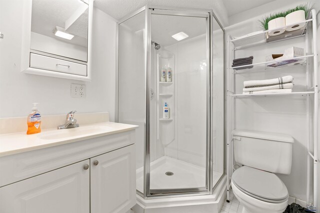 735 8th, Spearfish, SD 57783 - bathroom featuring vanity with extensive cabinet space, an enclosed shower, tile flooring, toilet, and a textured ceiling