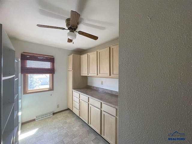 kitchen featuring ceiling fan and light tile flooring