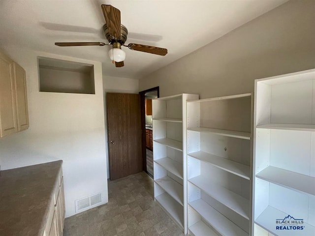 walk in closet with ceiling fan and tile floors