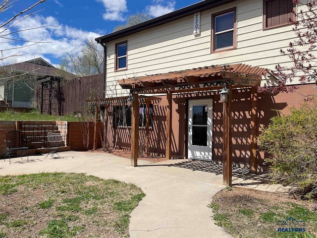 back of property featuring a pergola and a patio area