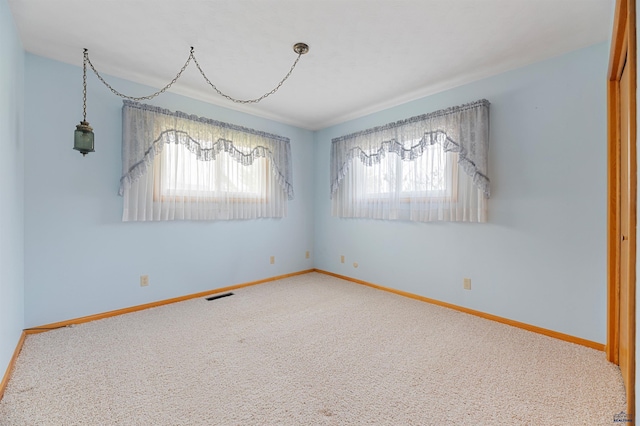 carpeted empty room with a healthy amount of sunlight