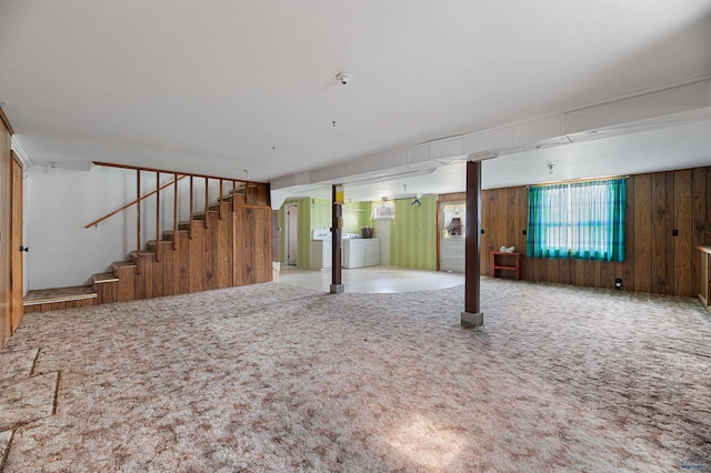 basement with independent washer and dryer, carpet, and wood walls